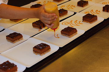 Image showing preparation of dessert plates for a chocolate cake louis XV