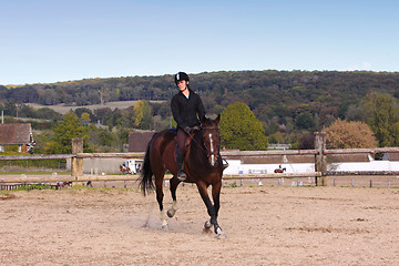 Image showing pretty young woman rider in a competition riding