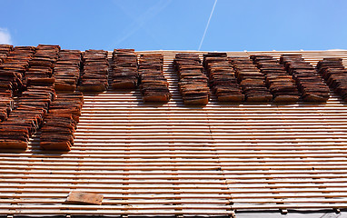 Image showing renovation of a tiled roof of an old house