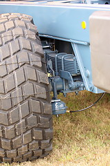 Image showing shock absorber and tire of a large farm trailer