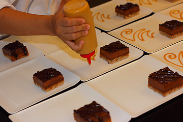 Image showing preparation of dessert plates for a chocolate cake louis XV