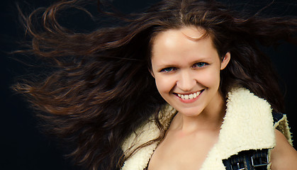 Image showing attractive girl with long hair in denim vest