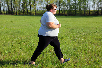 Image showing  overweight woman running on meadow