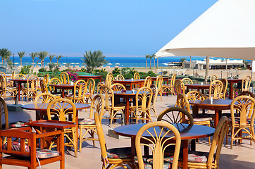 Image showing tables in cafe on terrace near sea