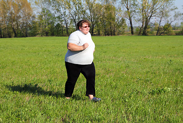 Image showing  overweight woman running on meadow