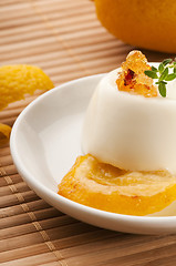 Image showing Vanilla Panna Cotta Dessert with lemon and fresh herbs