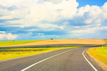 Image showing Empty curved road, blue sky