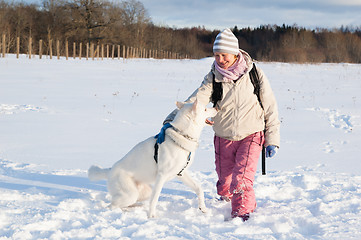 Image showing The woman with a dog in winter on walk