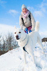 Image showing The woman with a dog in winter on walk