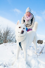 Image showing The woman with a dog in winter on walk