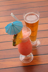 Image showing glass of fruit cocktail and a glass of beer