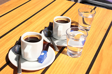 Image showing cups of coffee with a glass of water