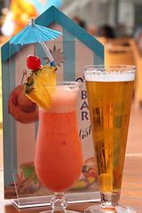 Image showing glass of fruit cocktail and a glass of beer