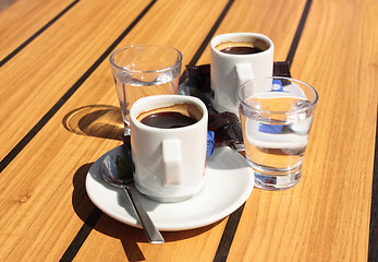 Image showing cups of coffee with a glass of water