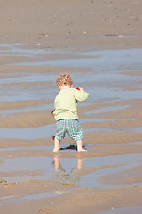 Image showing Children playing with sand on the beach