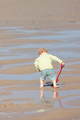 Image showing Children playing with sand on the beach