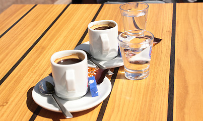 Image showing cups of coffee with a glass of water