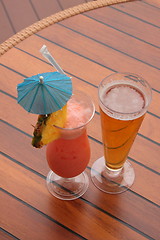 Image showing glass of fruit cocktail and a glass of beer