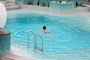 Image showing Man swimming in blue water of the pool