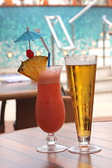 Image showing glass of fruit cocktail and a glass of beer