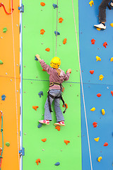 Image showing Child climbing on a climbing wall, outdoor