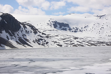 Image showing frozen lake and snowy mountains in norway