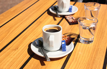 Image showing cups of coffee with a glass of water