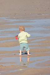 Image showing Children playing with sand on the beach