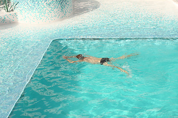 Image showing Man swimming in blue water of the pool