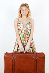 Image showing Girl with vintage suitcase anticipating travel