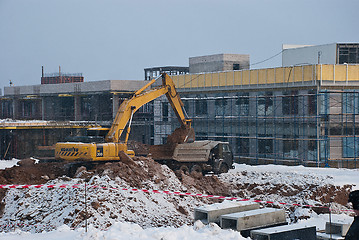 Image showing Tipper and Excavating Machine at a Construction Site in Winter