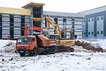 Image showing Dump Truck and Excavators at the Construction Site in Winter