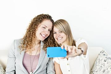 Image showing Two women taking photo with phone