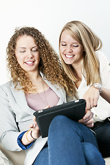 Image showing Two women using tablet computer