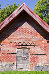 Image showing Rural farm building of brick wooden doors padlock 