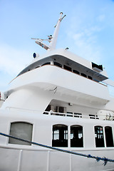 Image showing White tourist ship close up on blue sky