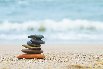 Image showing Stack of beach stones on sand