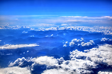 Image showing High in the sky, puffy white clouds