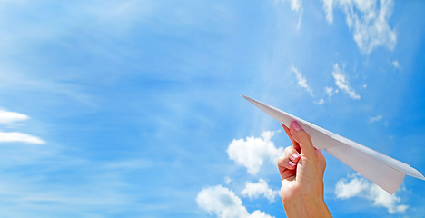 Image showing Throwing a paper plane in the sky