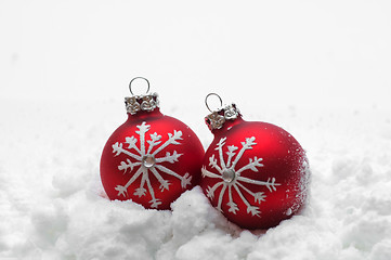 Image showing Red Christmas balls in snow