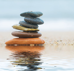 Image showing Stack of beach stones on sand