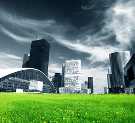 Image showing Big city and green fresh meadow