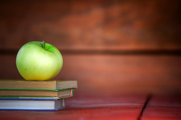 Image showing Apple on pile of books