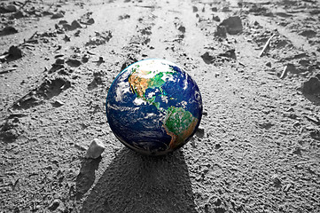 Image showing The Earth globe on rocky Mars like surface