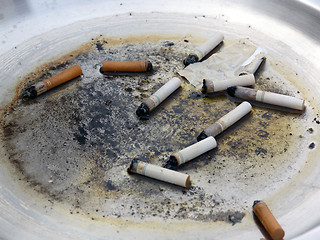 Image showing Cigarette butts in dirty metal ashtray