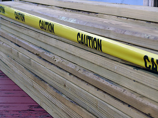 Image showing Stack of two by fours caution