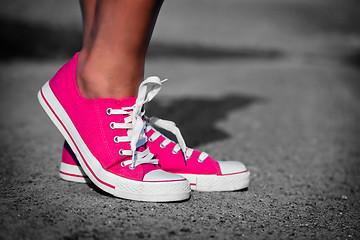 Image showing Pink sneakers on girl, woman legs