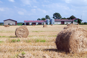 Image showing Farm buildings and haystacks