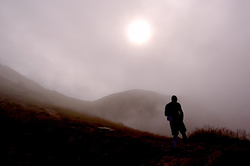 Image showing Man and foggy mountains