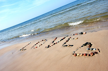 Image showing Word LOVE on beach sand